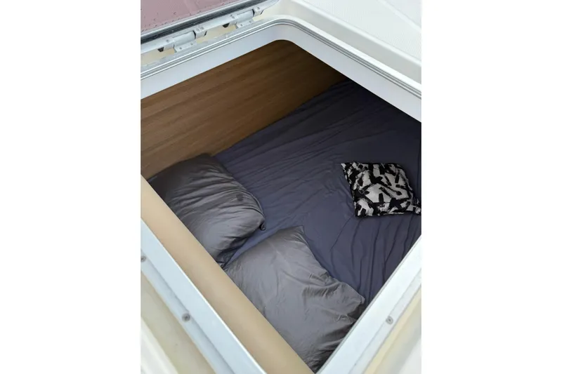 Manila Spirit Yacht Photos Pics Cozy sleeping area in a 2012 Dean 5000, featuring pillows and a patterned cushion.