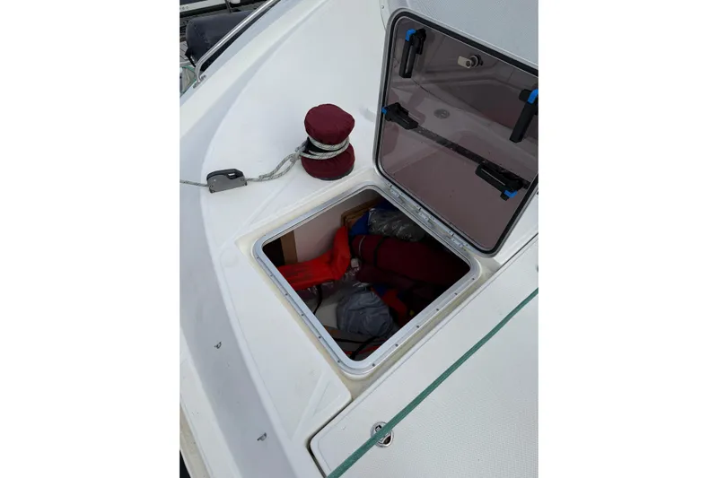 Manila Spirit Yacht Photos Pics Open storage compartment on 2012 Dean 5000 boat deck with visible gear inside.