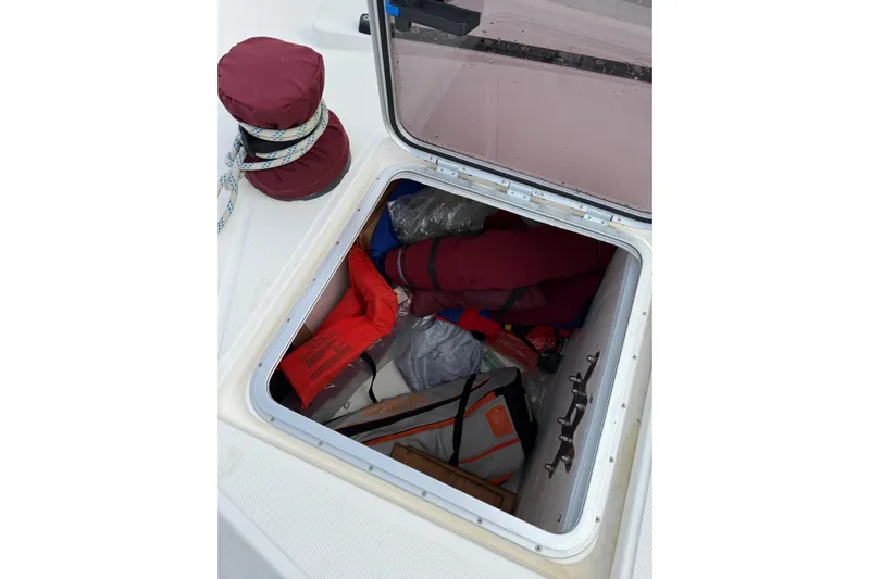 Manila Spirit Yacht Photos Pics Open storage compartment on 2012 Dean 5000 boat, containing life jackets and gear.