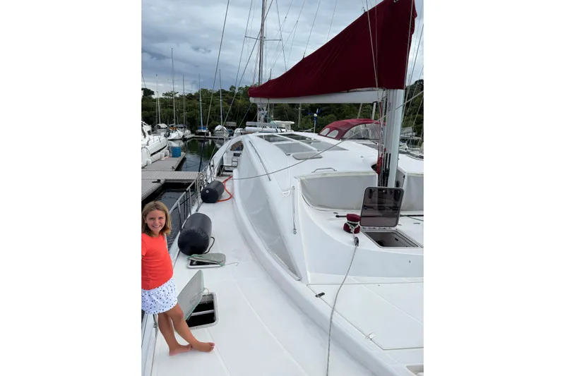 Manila Spirit Yacht Photos Pics Sailboat Dean 5000, 2012 model, docked with a person on deck, red sail cover.