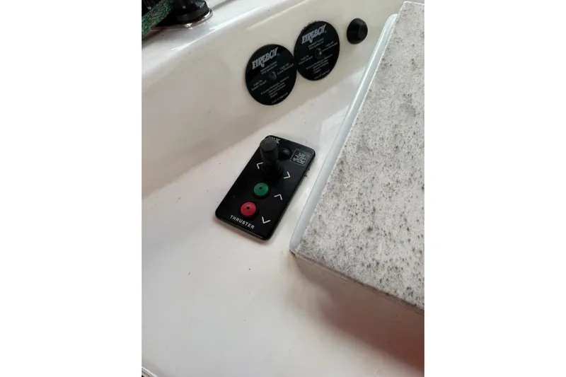 Manila Spirit Yacht Photos Pics Control panel of a 2012 Dean 5000 boat with thruster buttons and Fireboy labels.