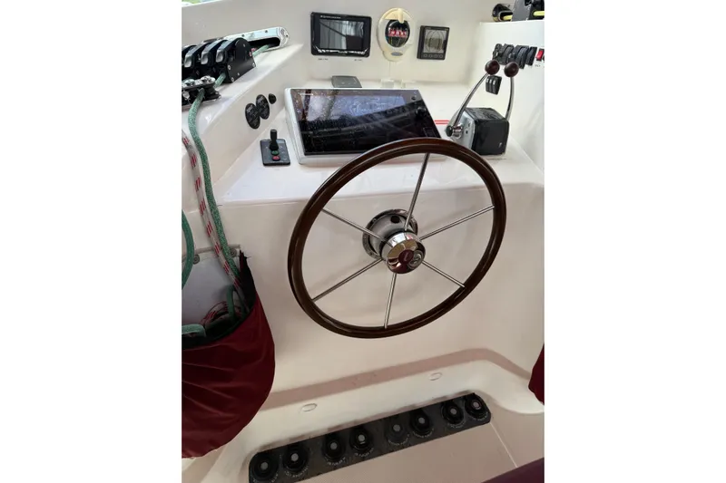 Manila Spirit Yacht Photos Pics Steering wheel and controls of a 2012 Dean 5000 boat cockpit.