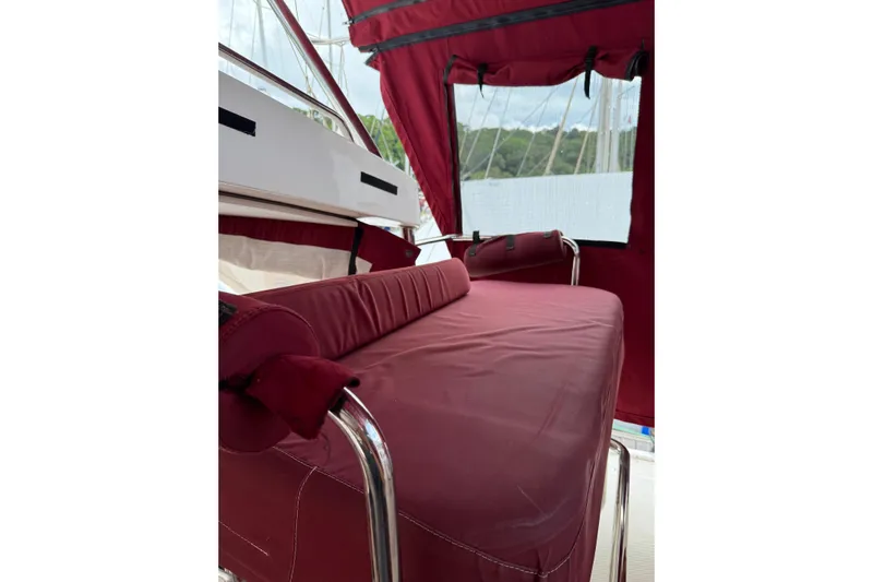 Manila Spirit Yacht Photos Pics Red cushioned seating area on a 2012 Dean 5000 boat, with protective canopy.