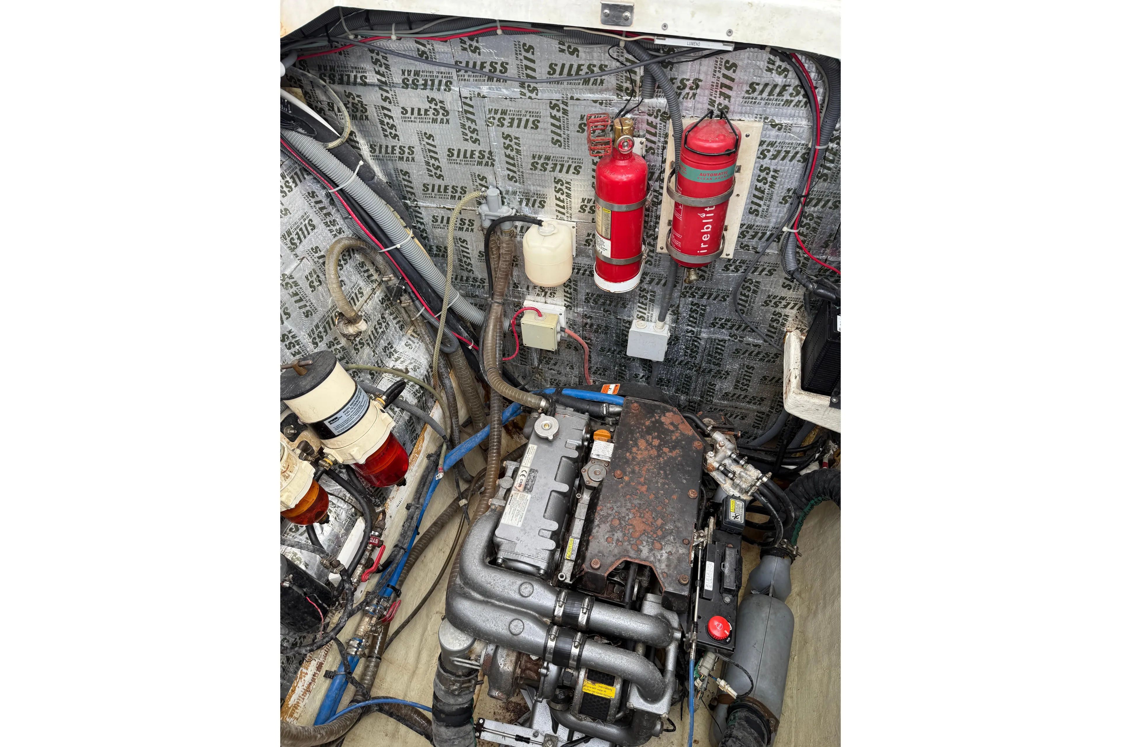Manila Spirit Yacht Photos Pics Engine room of a 2012 Dean 5000 boat with fire extinguishers and wiring.