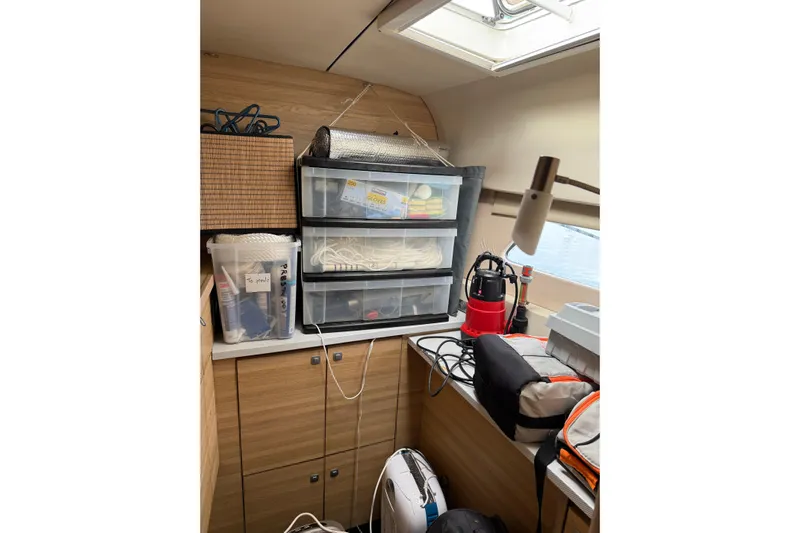 Manila Spirit Yacht Photos Pics Storage area inside a 2012 Dean 5000 boat with organized containers and equipment.