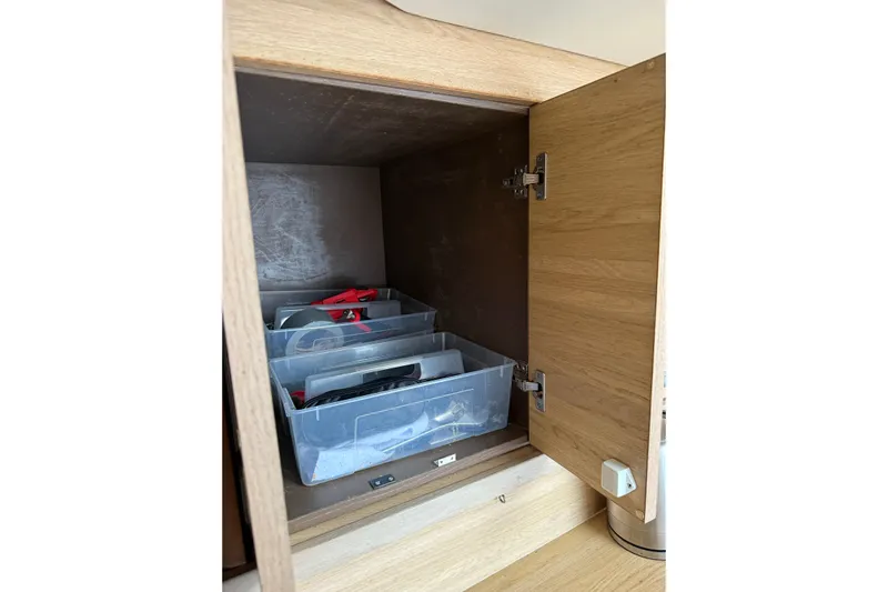 Manila Spirit Yacht Photos Pics Open wooden cabinet with plastic storage bins containing tools, Dean 5000, 2012 model.