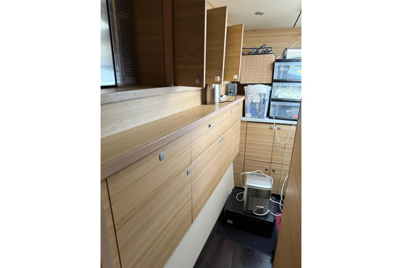 Manila Spirit Yacht Photos Pics Modern wooden cabinetry in a 2012 Dean 5000 interior, featuring organized storage and appliances.