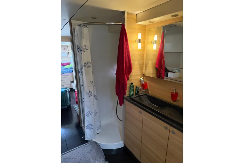 Manila Spirit Yacht Photos Pics Compact bathroom in a 2012 Dean 5000, featuring a shower and wooden cabinetry.