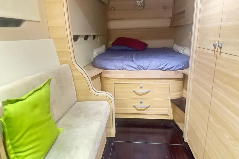 Manila Spirit Yacht Photos Pics Cozy cabin interior with bed, sofa, and wooden storage in a 2012 Dean 5000 model.