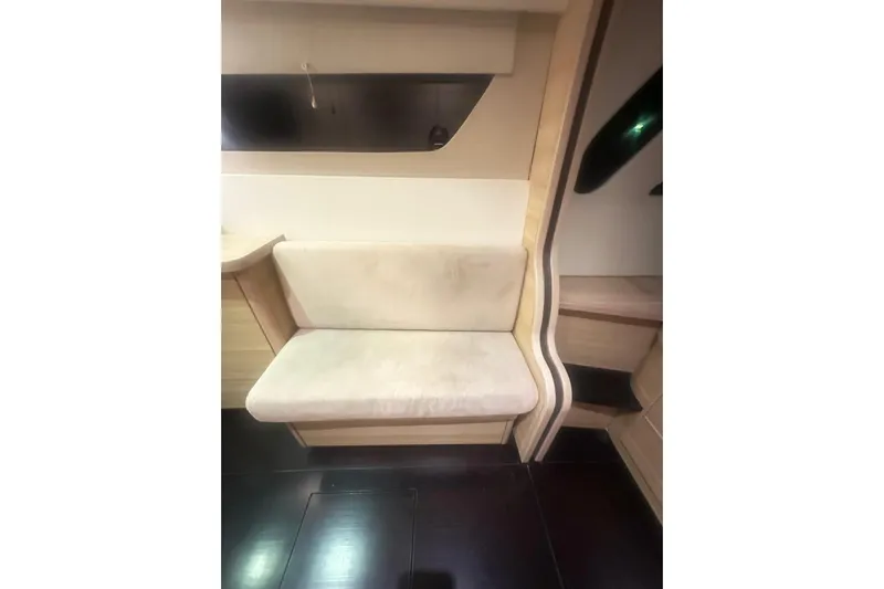 Manila Spirit Yacht Photos Pics Interior seating area of a 2012 Dean 5000 yacht, featuring light wood and upholstery.