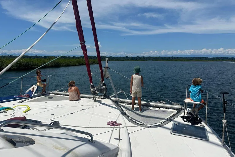 Manila Spirit Yacht Photos Pics Children enjoying a sunny day on a 2012 Dean 5000 catamaran, surrounded by scenic water views.