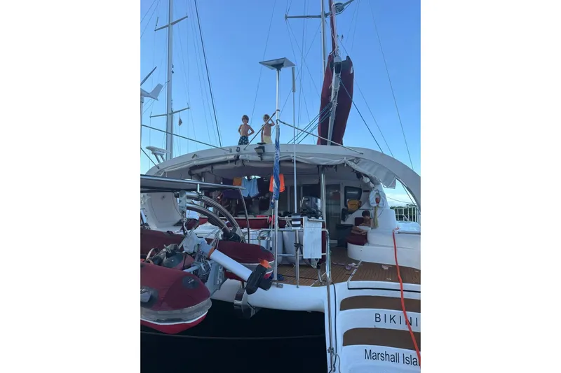 Manila Spirit Yacht Photos Pics 2012 Dean 5000 yacht docked, featuring people on deck, Marshall Islands registration.