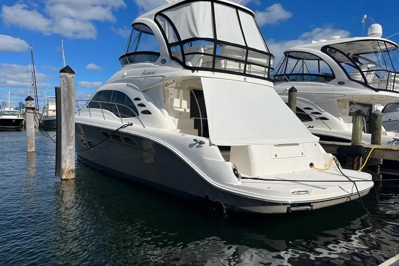 N/a Yacht Photos Pics 2006 Sea Ray 52 Sedan Bridge yacht docked at marina under blue sky.