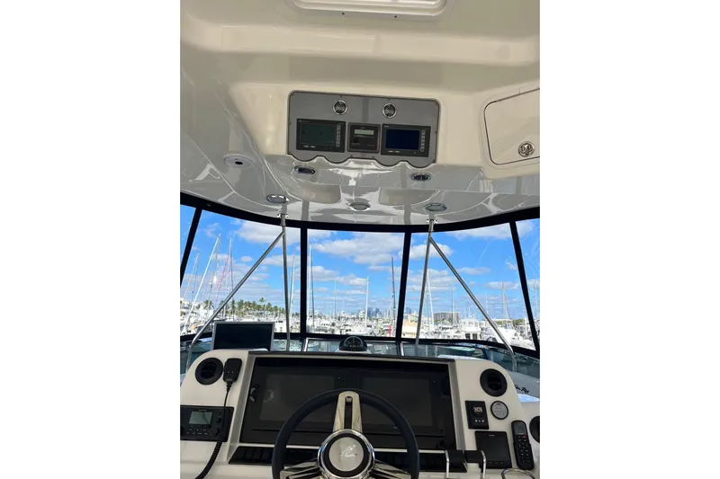 N/a Yacht Photos Pics 2006 Sea Ray 52 Sedan Bridge helm with modern navigation equipment and marina view.