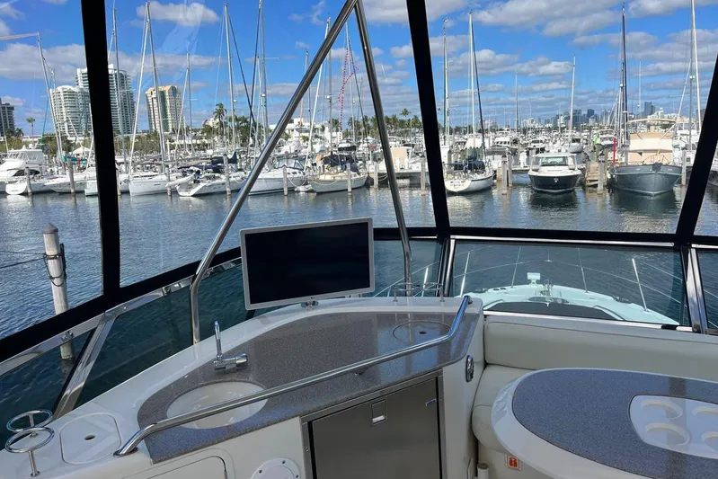 N/a Yacht Photos Pics 2006 Sea Ray 52 Sedan Bridge yacht interior with marina view, featuring a sleek control panel.