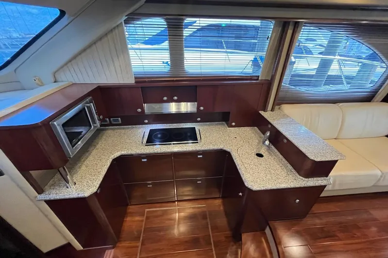 N/a Yacht Photos Pics Luxurious 2006 Sea Ray 52 Sedan Bridge yacht kitchen with modern appliances and elegant wood finish.
