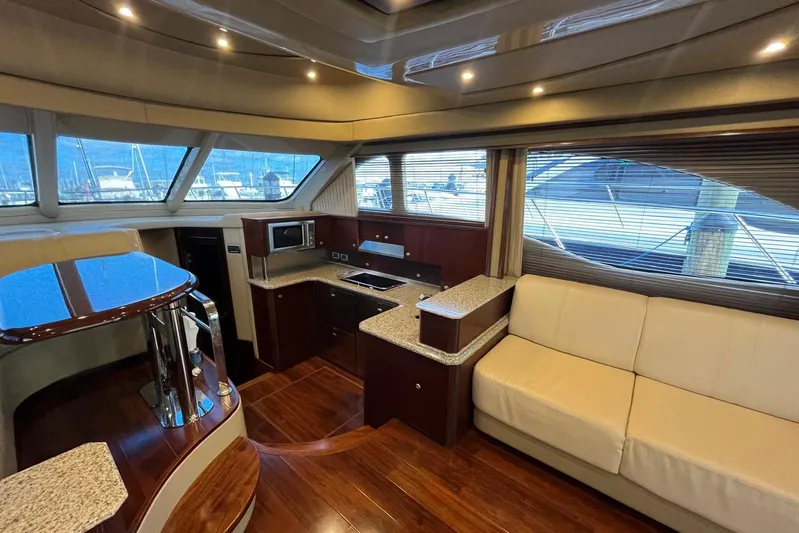 N/a Yacht Photos Pics Luxurious interior of 2006 Sea Ray 52 Sedan Bridge yacht with modern kitchen and seating.