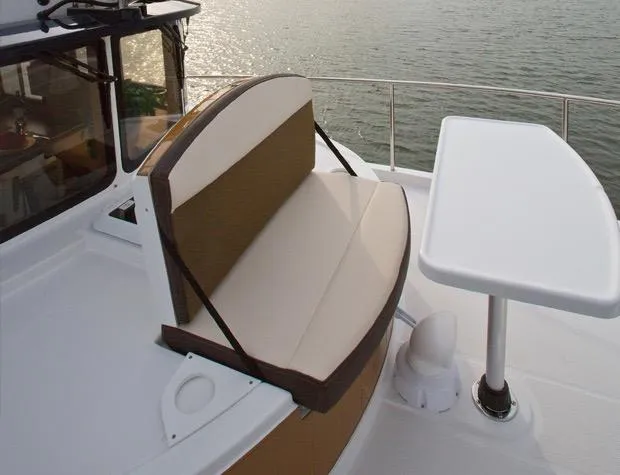 The Western Yacht Photos Pics 2014 Ranger Tugs R-31CB boat seating area with table, overlooking water.