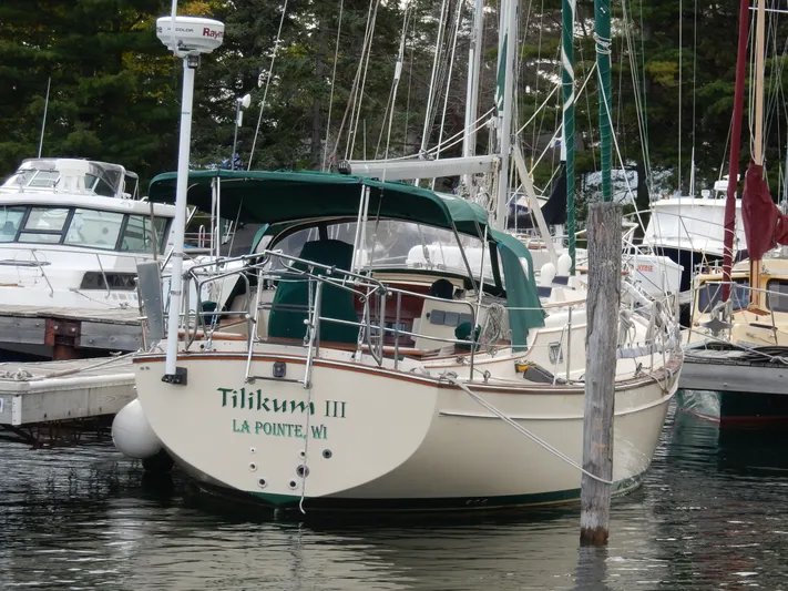 Tilikum III Yacht Photos Pics Island Packet 40 sailboat, 1997 model, docked at marina with green canopy.
