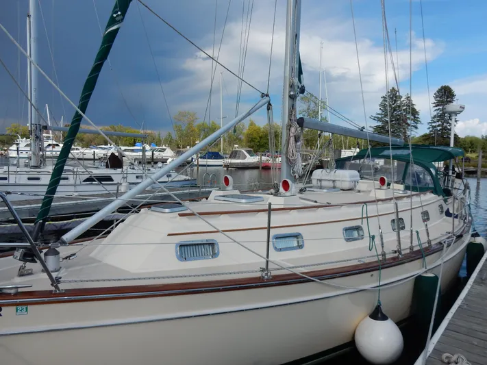 Tilikum III Yacht Photos Pics 1997 Island Packet 40 sailboat docked at a marina under a cloudy sky.