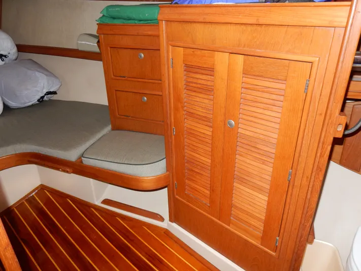 Tilikum III Yacht Photos Pics Interior of 1997 Island Packet 40 sailboat with wooden cabinetry and seating area.
