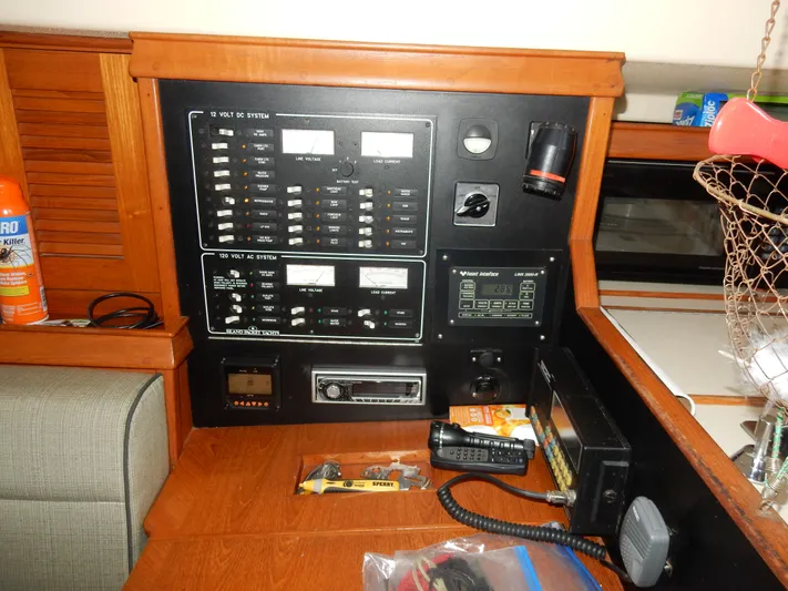 Tilikum III Yacht Photos Pics Electrical control panel on a 1997 Island Packet 40 sailboat, featuring various switches and equipment.