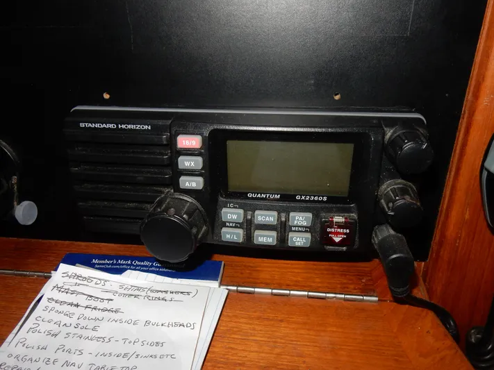 Tilikum III Yacht Photos Pics Standard Horizon radio on 1997 Island Packet 40 sailboat, with notes nearby.