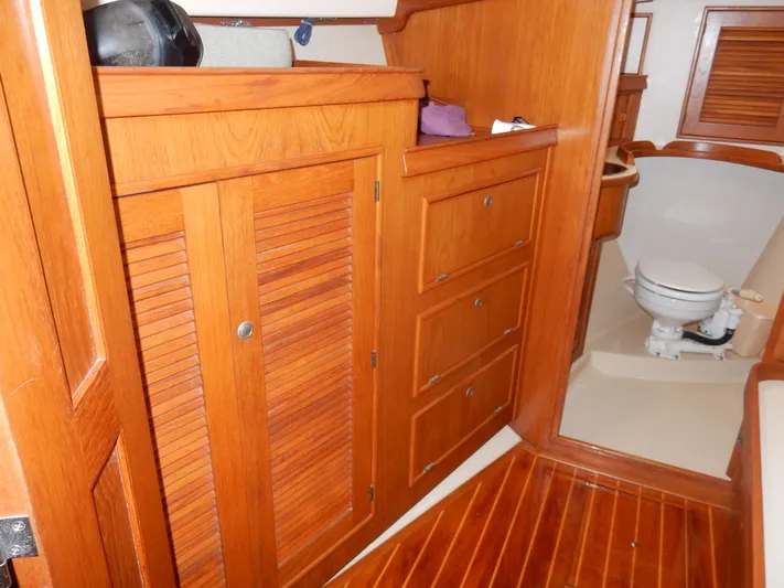 Tilikum III Yacht Photos Pics Interior of 1997 Island Packet 40 sailboat with wooden cabinetry and marine toilet.