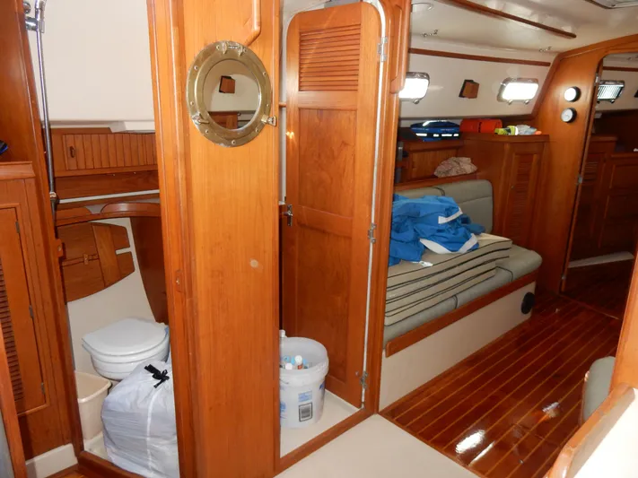 Tilikum III Yacht Photos Pics Interior of 1997 Island Packet 40 sailboat with wooden finishes and seating area.