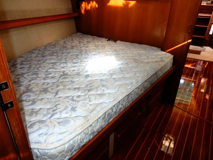 Tilikum III Yacht Photos Pics Cozy cabin bed in 1997 Island Packet 40 sailboat with wooden interior.