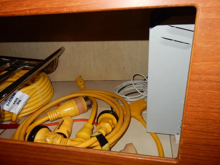 Tilikum III Yacht Photos Pics Storage compartment with yellow cables and equipment on a 1997 Island Packet 40 sailboat.