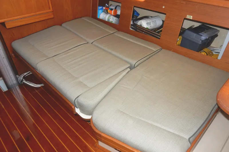 Tilikum III Yacht Photos Pics Interior view of 1997 Island Packet 40 sailboat with cushioned seating and wooden flooring.