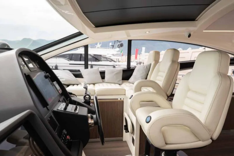  Yacht Photos Pics Luxurious interior of a 2005 Pershing 62 yacht with plush seating and modern controls.