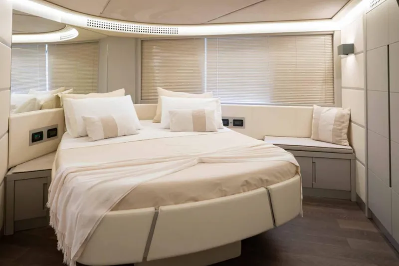  Yacht Photos Pics Luxurious bedroom interior of 2005 Pershing 62 yacht with modern design and cozy bedding.