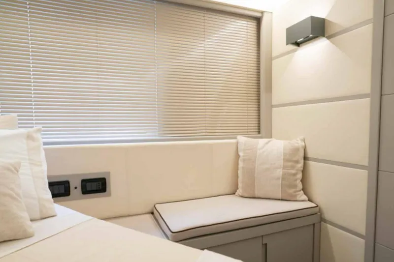  Yacht Photos Pics Interior of 2005 Pershing 62 yacht, featuring a cozy seating area with neutral tones.