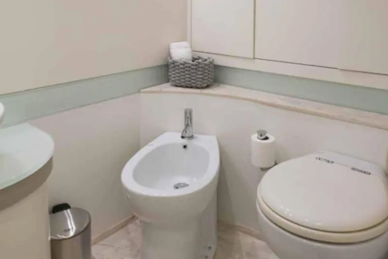  Yacht Photos Pics Bathroom interior of 2005 Pershing 62 yacht, featuring toilet and bidet.