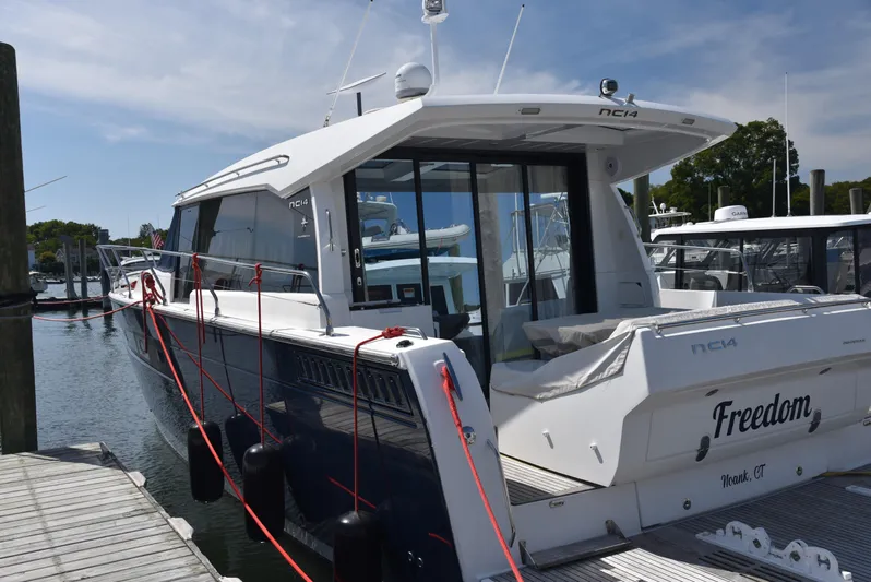 "freedom" Yacht Photos Pics 2016 Jeanneau NC 14 yacht docked at marina, featuring sleek design and modern amenities.