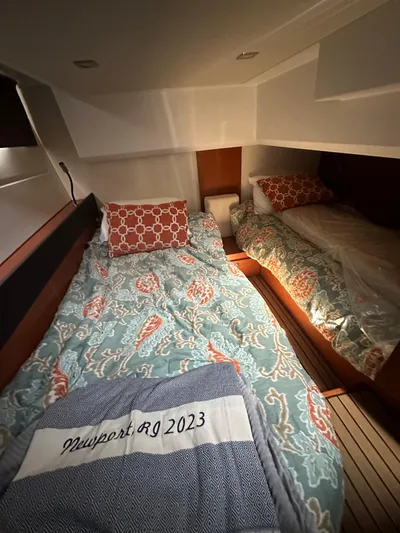"freedom" Yacht Photos Pics Cabin interior of 2016 Jeanneau NC 14 with patterned bedding and Newport blanket.