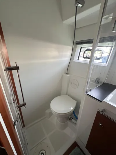 "freedom" Yacht Photos Pics 2016 Jeanneau NC 14 bathroom with shower, toilet, and window.