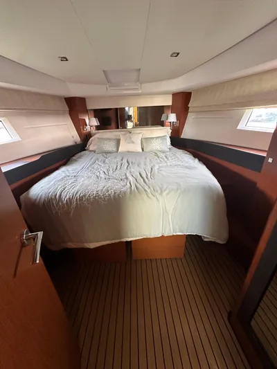 "freedom" Yacht Photos Pics 2016 Jeanneau NC 14 yacht bedroom with cozy double bed and elegant wood finish.