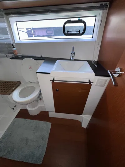 "freedom" Yacht Photos Pics 2016 Jeanneau NC 14 bathroom with sink, toilet, and window.
