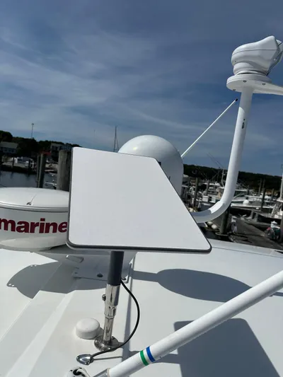 "freedom" Yacht Photos Pics 2016 Jeanneau NC 14 boat with radar and satellite equipment at a marina.