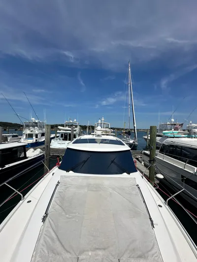 "freedom" Yacht Photos Pics 2016 Jeanneau NC 14 yacht docked at a marina under a clear blue sky.
