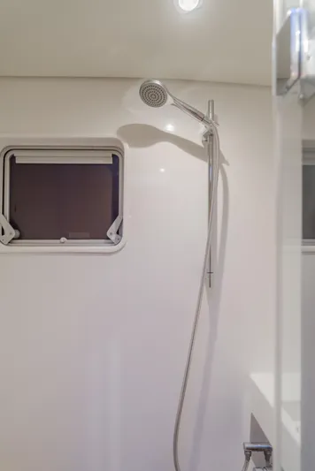 Sunset O Yacht Photos Pics Modern shower area in 2019 Lagoon 620 yacht with window and sleek fixtures.