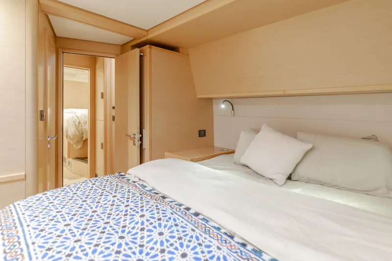 Sunset O Yacht Photos Pics Luxurious bedroom interior of 2019 Lagoon 620 yacht with elegant bedding and modern design.