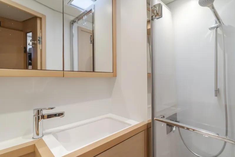 Sunset O Yacht Photos Pics Modern bathroom interior on 2019 Lagoon 620 yacht, featuring sleek sink and shower.