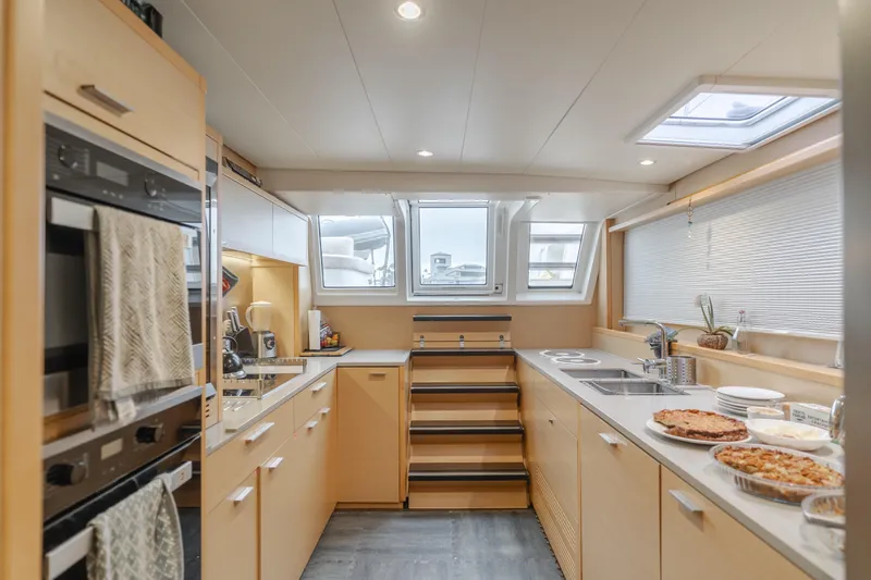 Sunset O Yacht Photos Pics Modern kitchen interior on 2019 Lagoon 620 yacht, featuring sleek design and ample natural light.