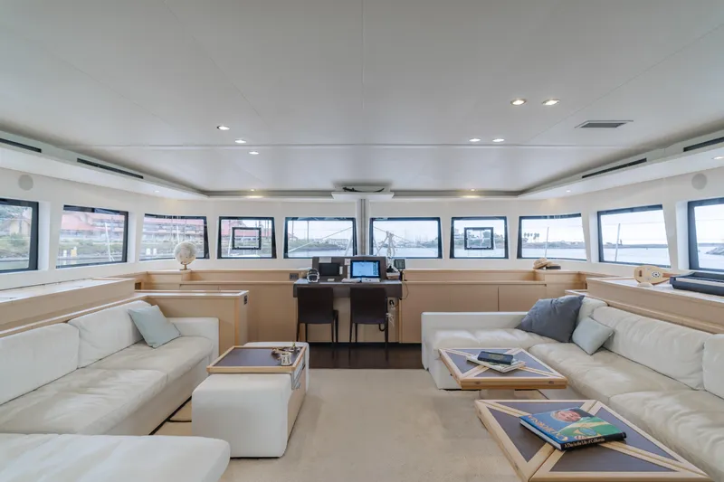 Sunset O Yacht Photos Pics Luxurious interior of 2019 Lagoon 620 yacht with modern furnishings and panoramic windows.