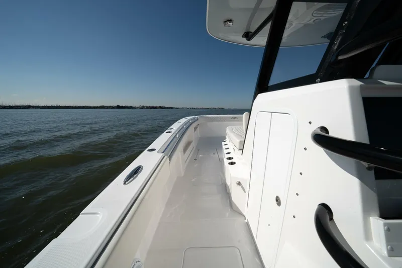  Yacht Photos Pics 2021 Invincible 35 Catamaran on calm waters, showcasing sleek design and spacious deck.