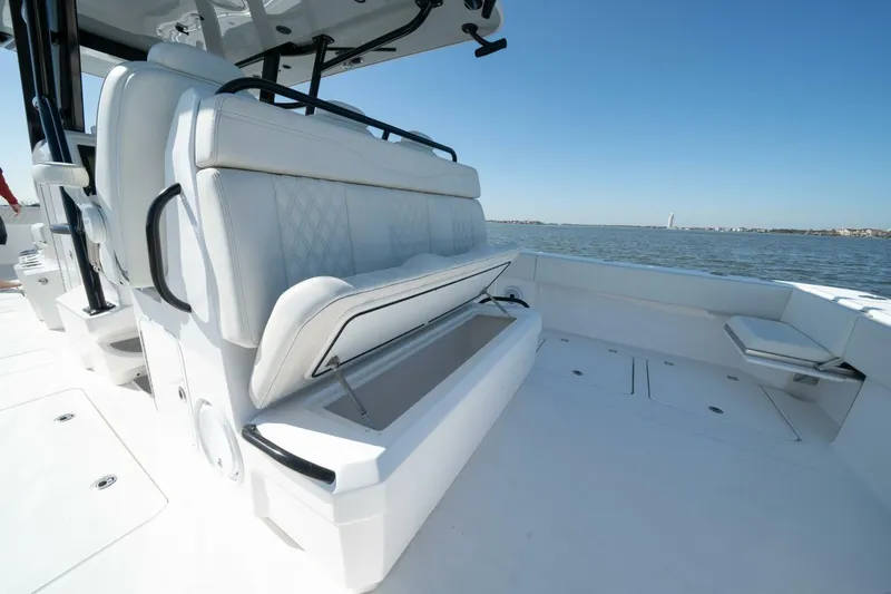  Yacht Photos Pics 2021 Invincible 35 Catamaran interior with open storage, white seating, and ocean view.